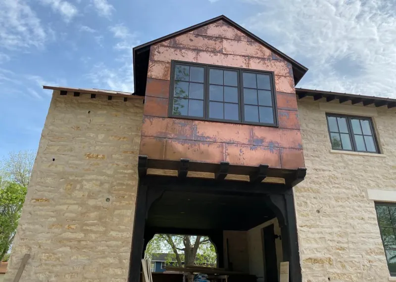Copper metal panel facade on a stone building for Skylight Installation in Citrus Park